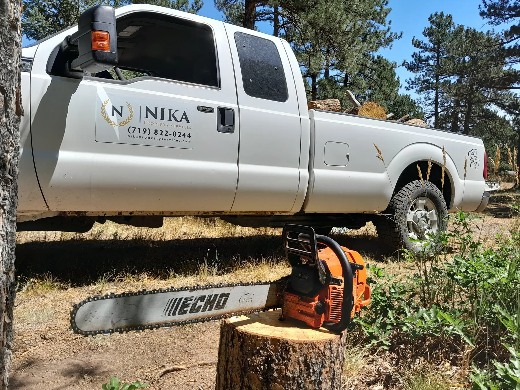 NIKA Property Services truck and chainsaw at a Colorado Springs mitigation project